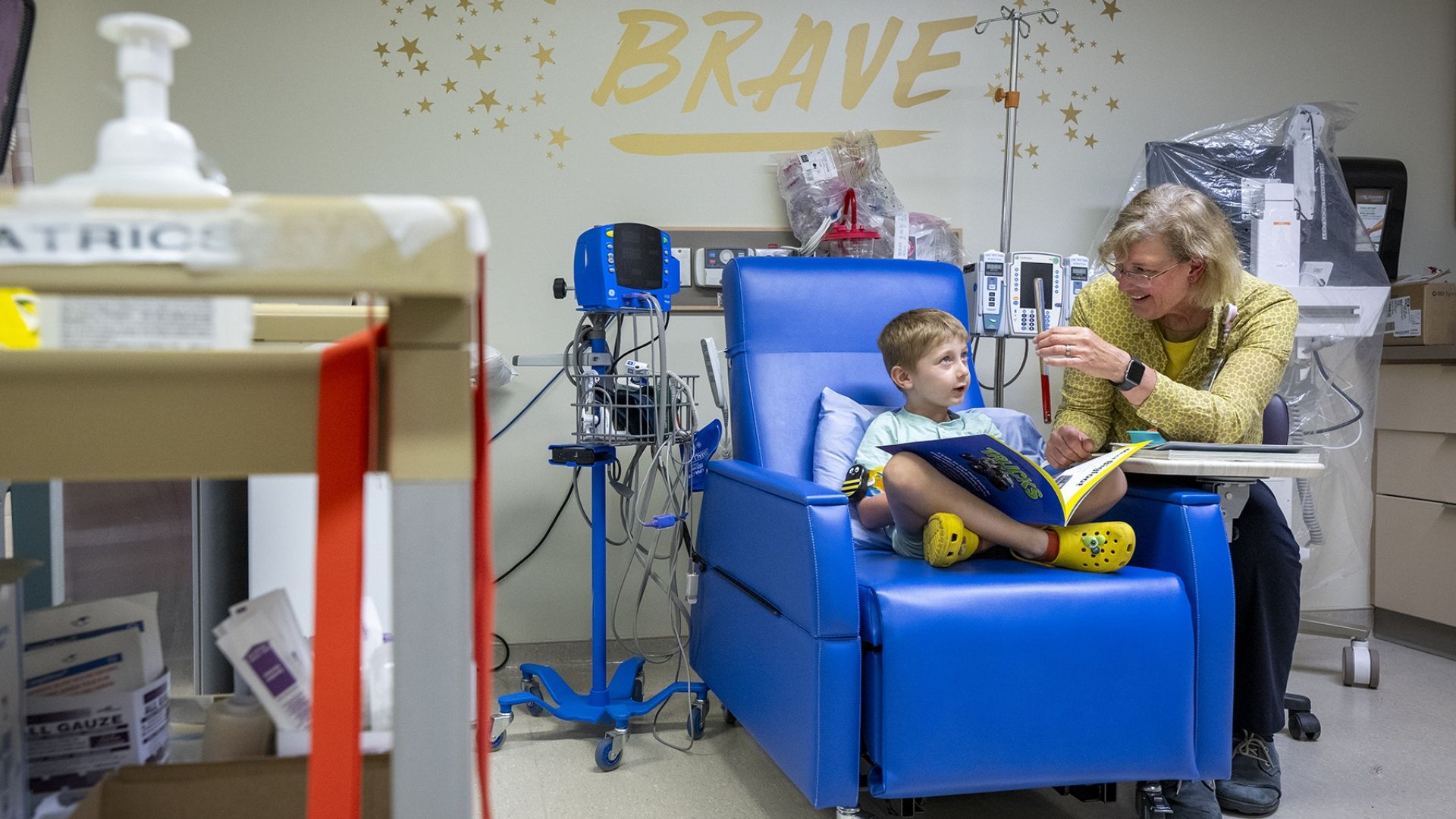 a child life expert talking to a patient in a clinical care area
