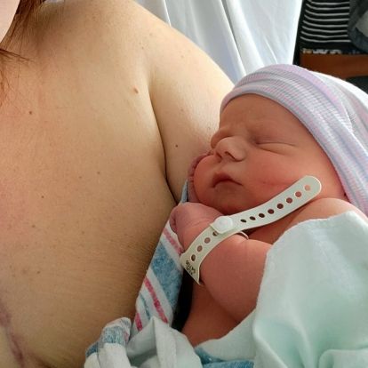 a newborn baby being held by his mother