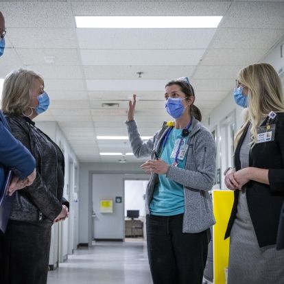 Dr. Amy Acker speaks with government representatives inside the COPC
