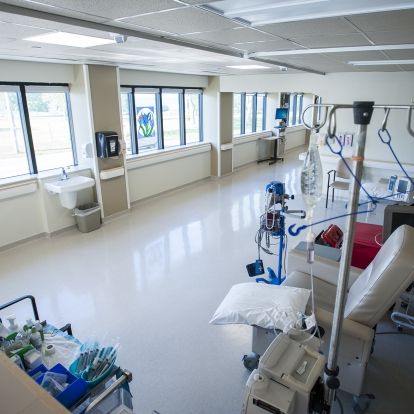 A row of chemotherapy chairs face windows looking out to Lake Ontario in KHSC.