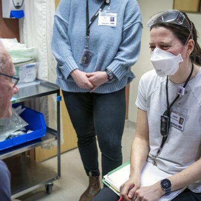A speech language pathologist speaks with a patient.