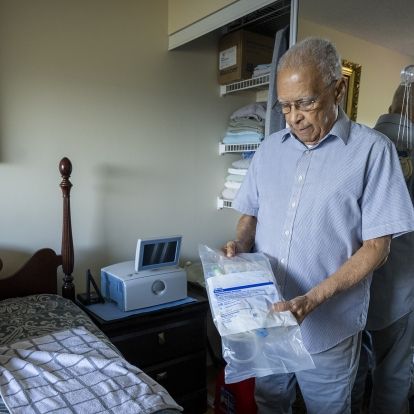 Philippe showing his some of his home dialysis supplies