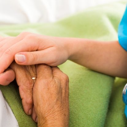Nurse and elderly hands