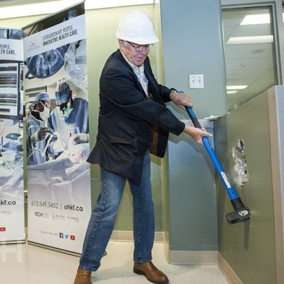 David Pattenden from the W.J. Henderson Foundation get the construction off to a start with a ceremonial swing of the hammer.