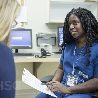 Dr. Julie Franis consults with a patient for a Pap Party clinic