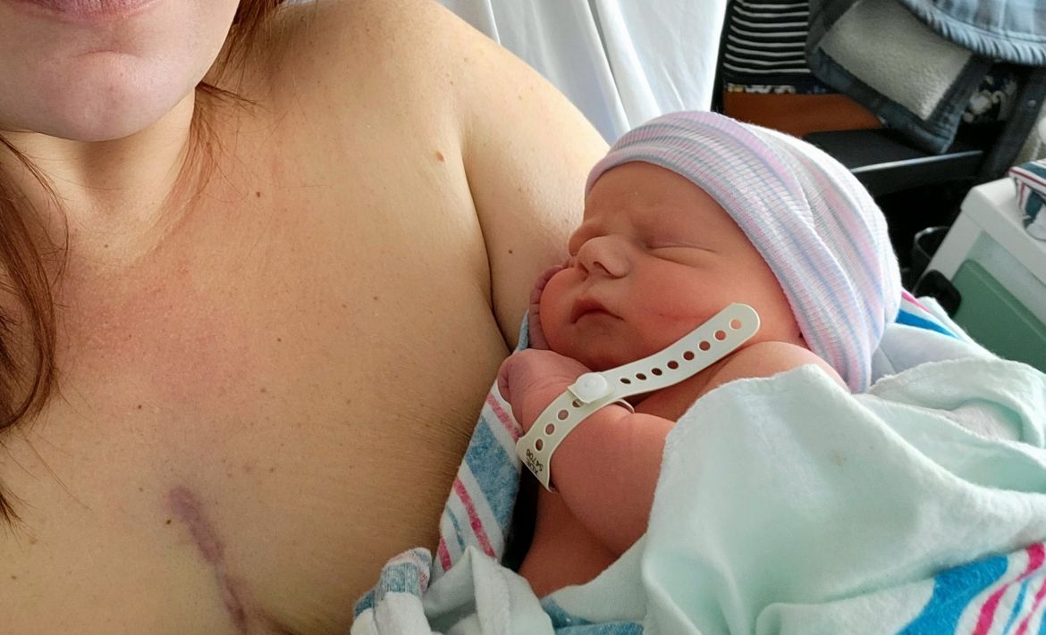 a newborn baby being held by his mother