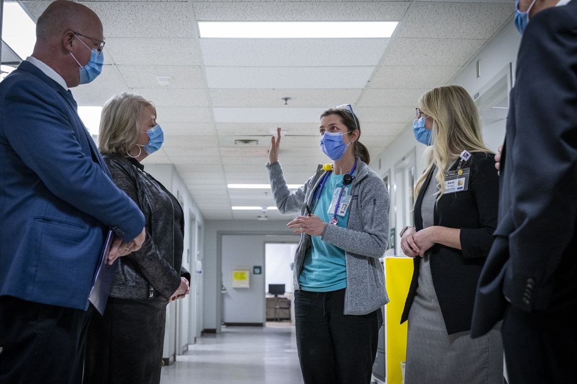 Dr. Amy Acker speaks with government representatives inside the COPC