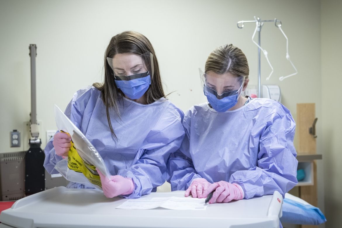 Staff examine cancer medication.