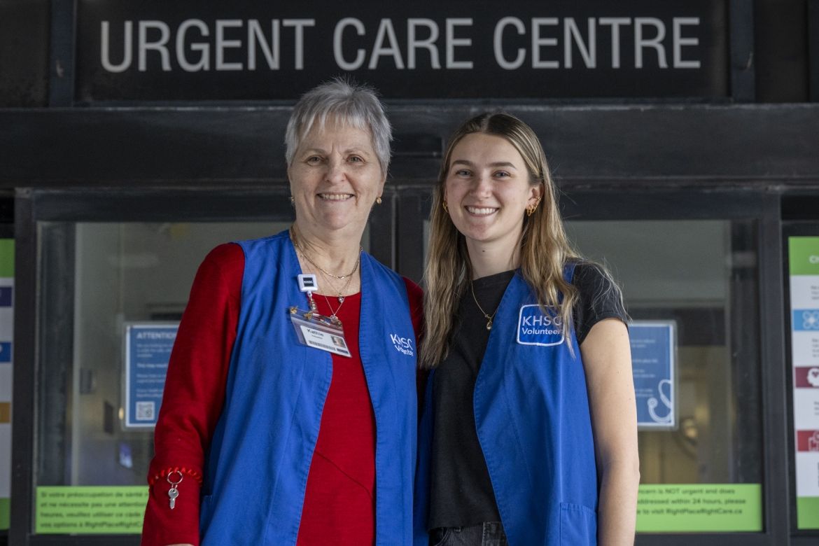 Volunteers in front of urgent care centre doors.