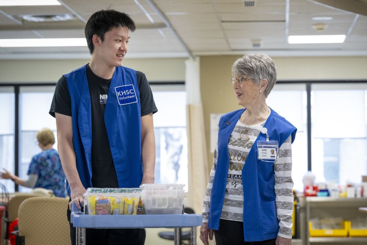 Daniel and Judy pushing snack cart.
