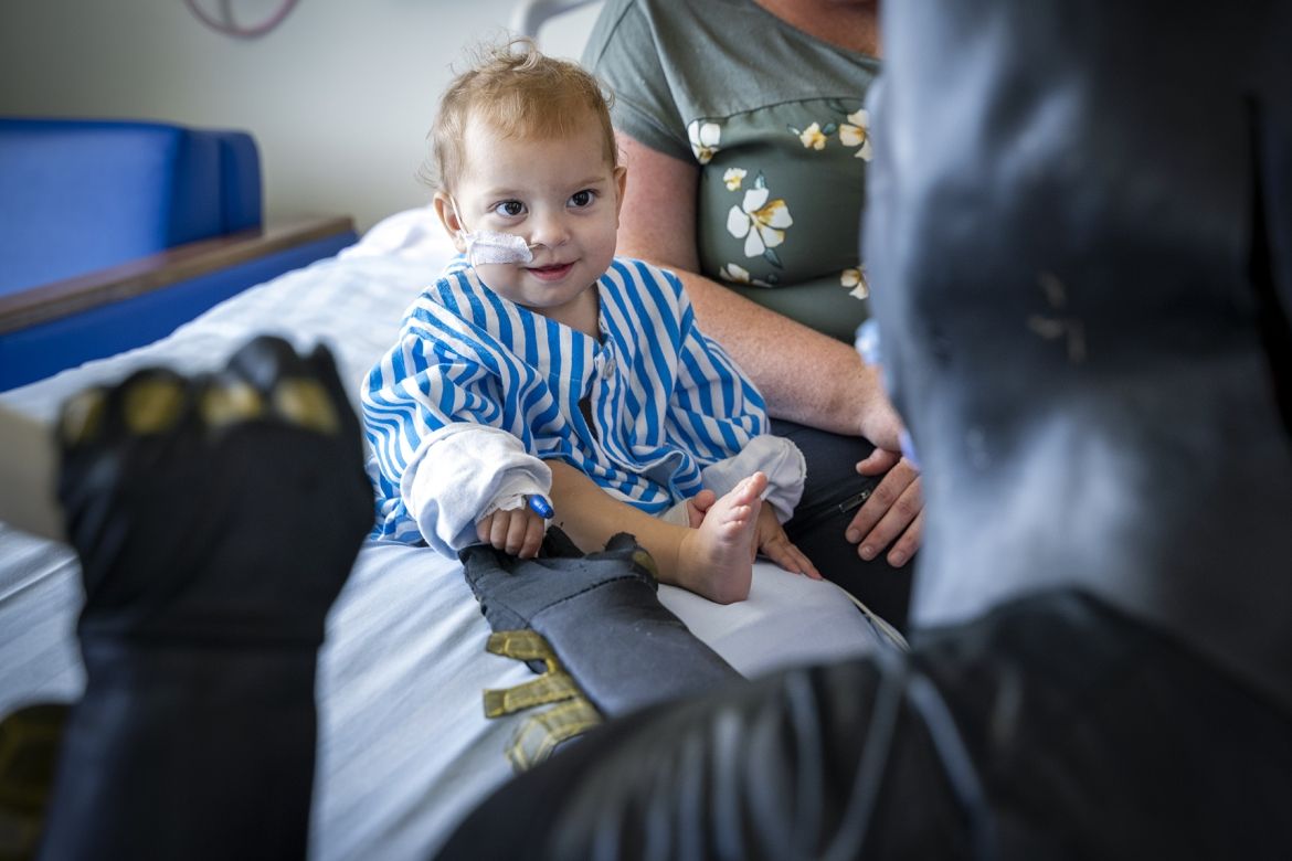 batman greets a smiling toddler at KHSC