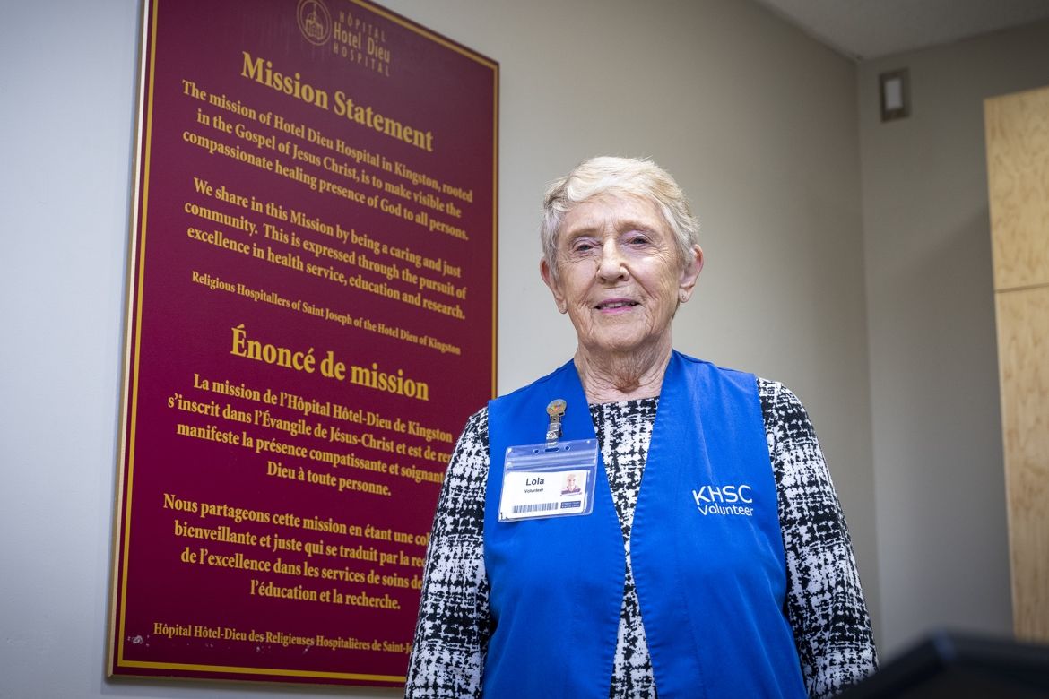 Lola standing infront of mission statement at HDH.