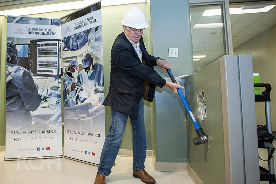 David Pattenden from the W.J. Henderson Foundation get the construction off to a start with a ceremonial swing of the hammer.