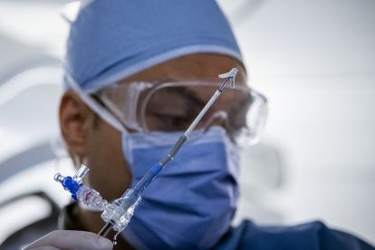 Dr. Abuzeid holds a mitral clip while performing a valve repair at KHSC.