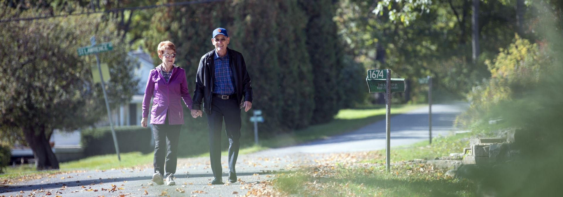 a couple walking down the street holding hands