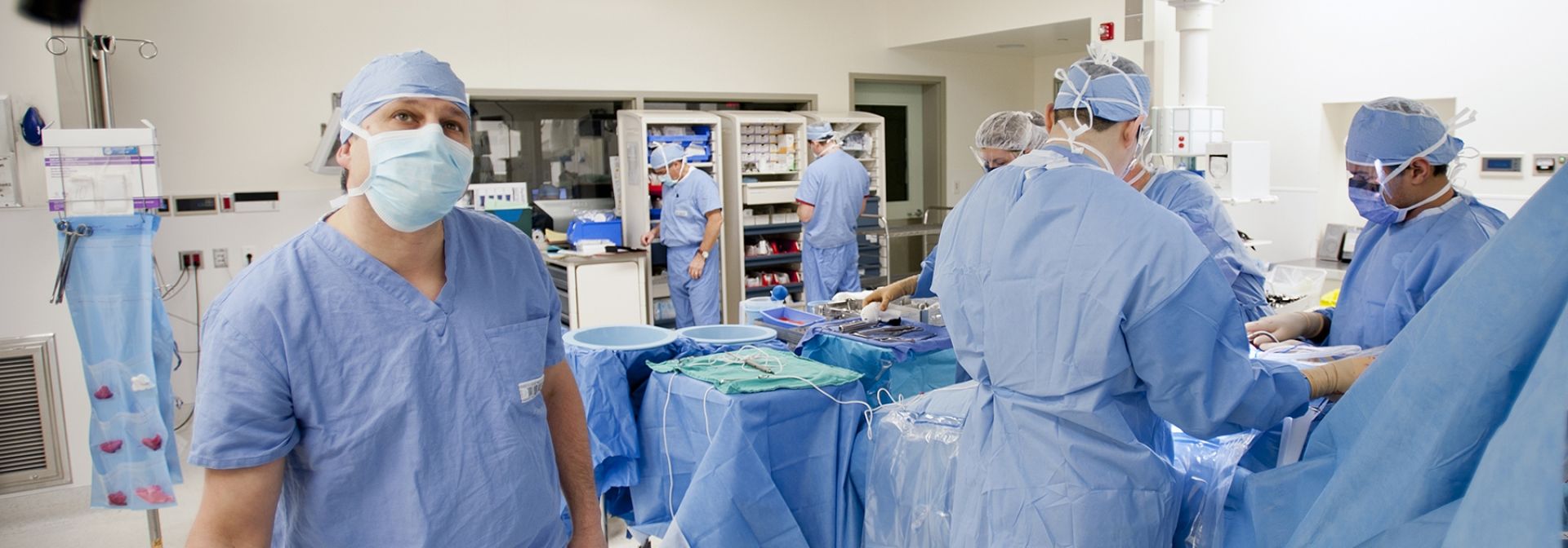 Drs with patient in an operating room.