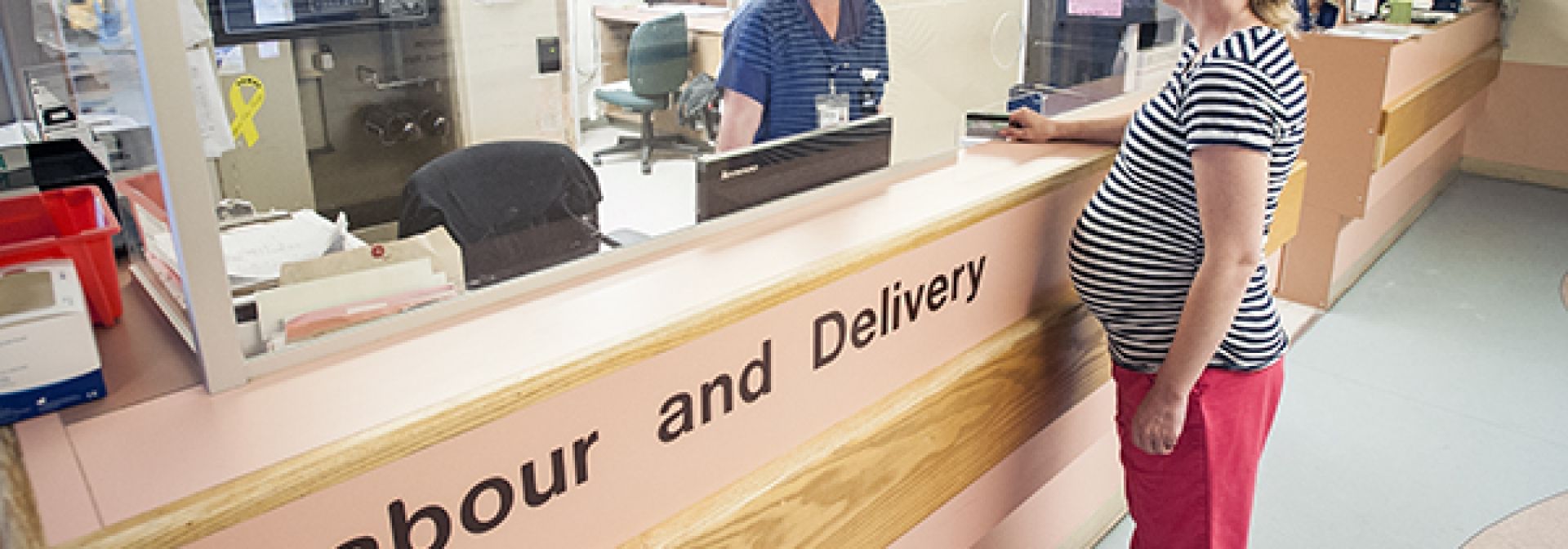 Two nurses talking at a desk