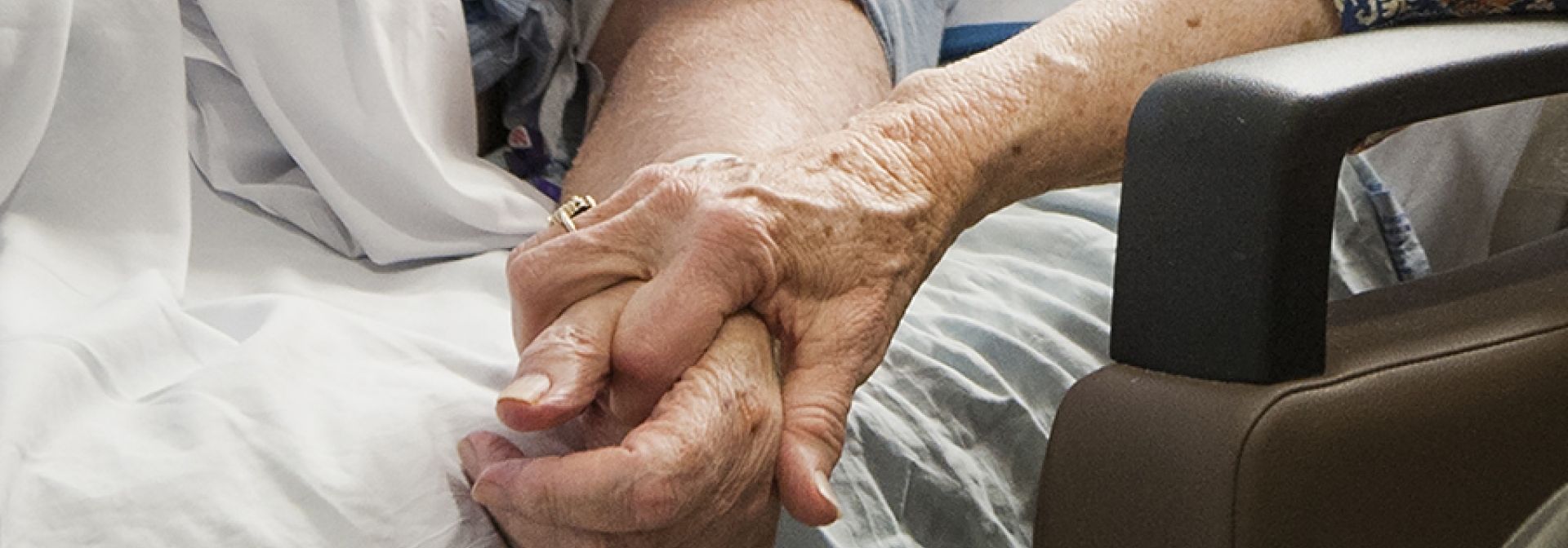 Patient holding hands with a family member