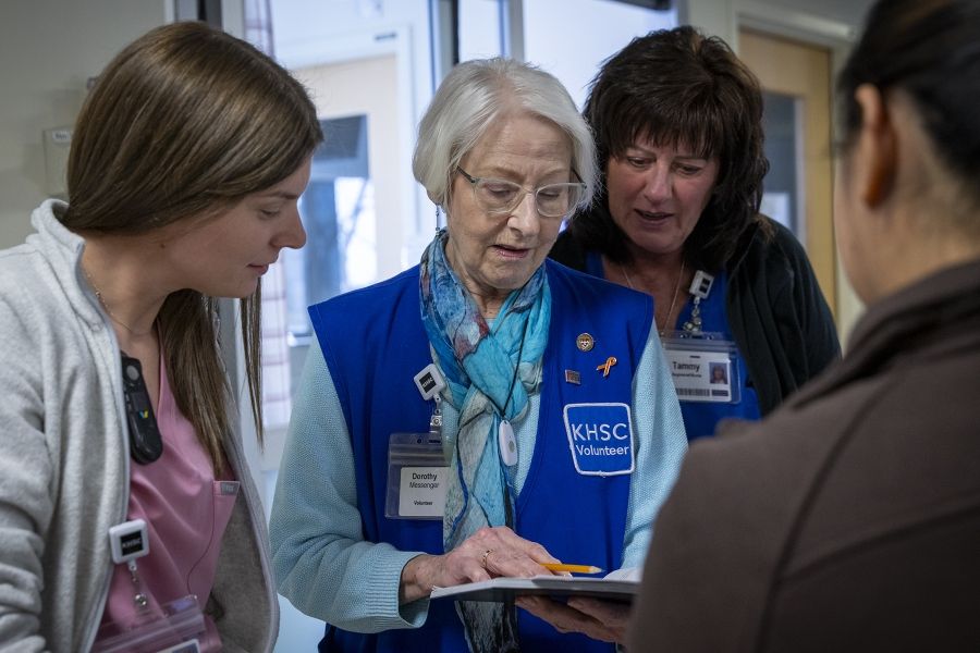 A volunteer working with staff in the ICU.