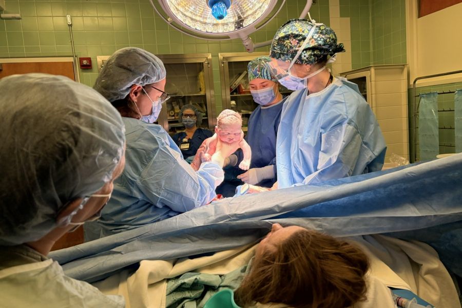 frontline staff show a baby born by c-section