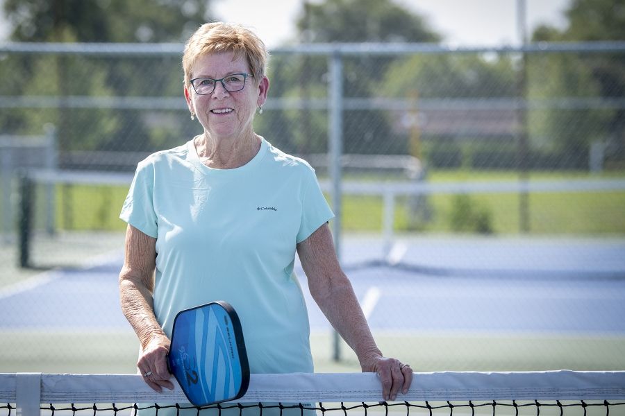 a woman holding a pickleball racket