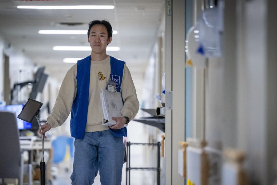 KHSC volunteer walks through KGH site hallway.