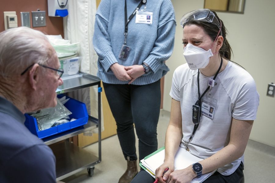 A speech language pathologist speaks with a patient.