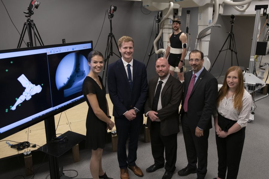Researcher Dr. Michael Rainbow (centre) and Kevin Deluzio, dean of engineering and applied science, with graduate students (L-R) Lauren Welte, Mitchell Wheatley, Liam Rodgers and Zoe Mack.