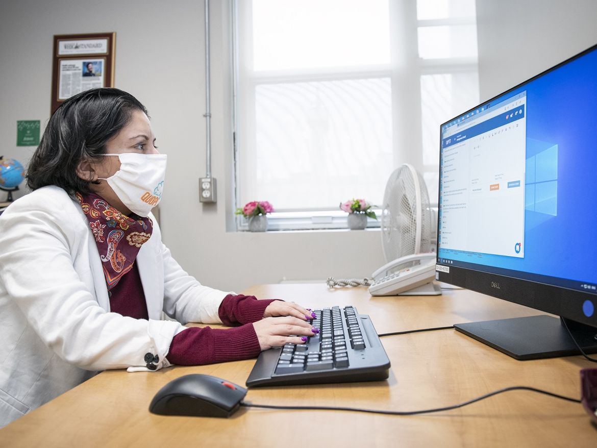 Dr. Nazanin Alavi working at her computer.