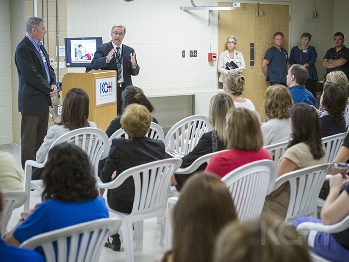 David Pichor speaks to a group of staff at a townhall meeting