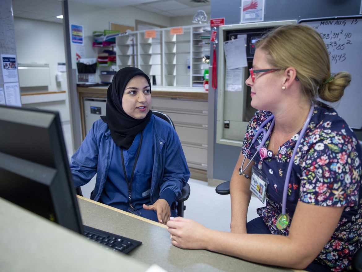 Registered nurse Holly Stroud and first-year resident Dr. Hossai Furmli on Kidd 5 Obstetrics and Gynecology discuss the CBME online evaluation portal