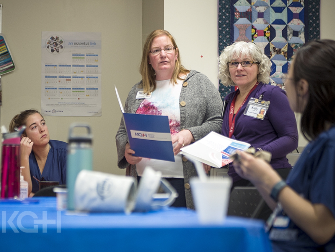 leaders speaking with staff in their work spaces.