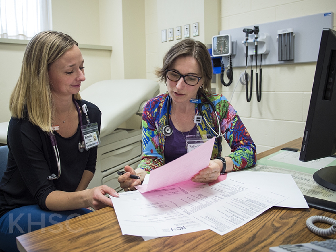 nurses consulting together in the clinic area