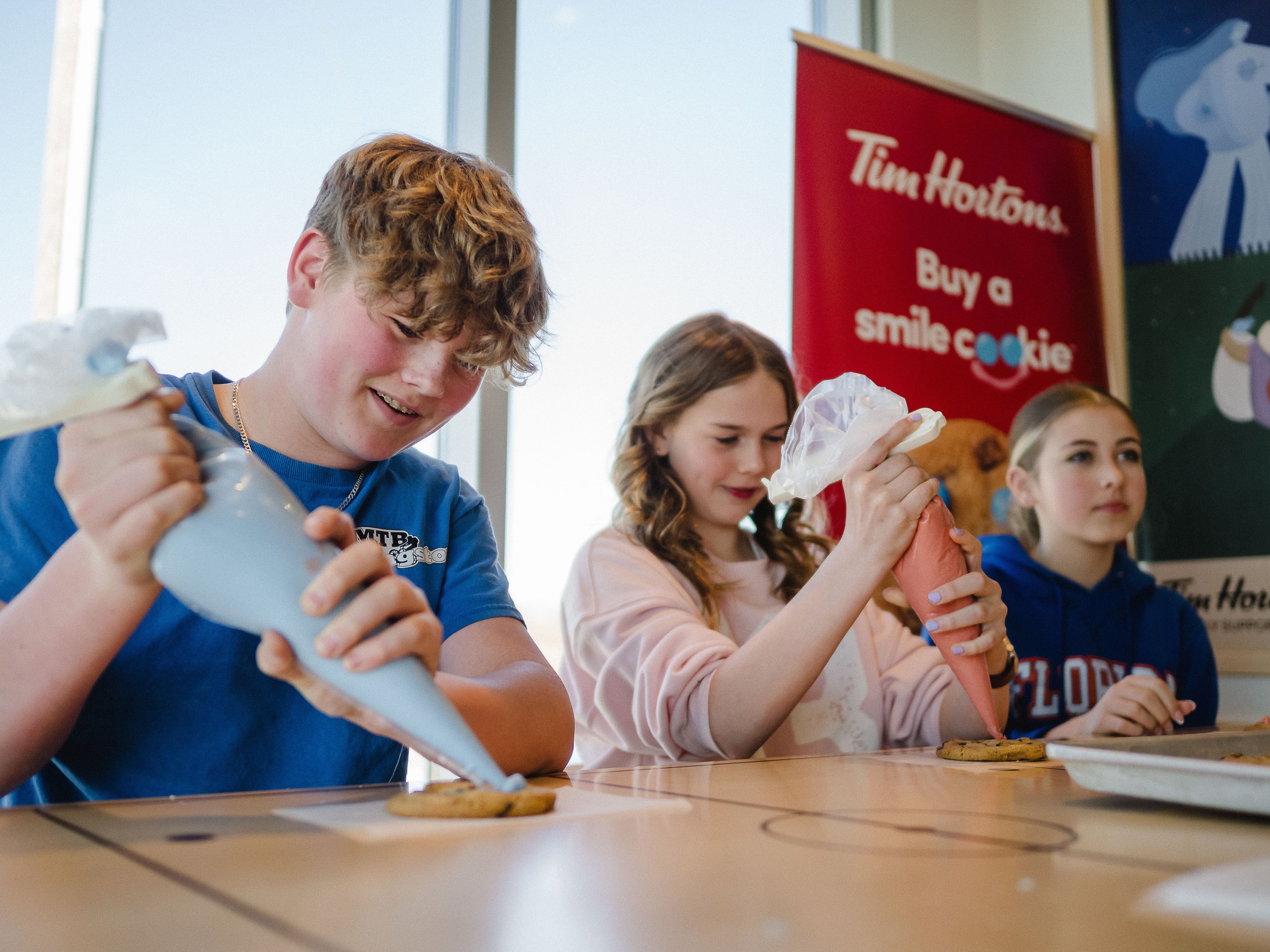Student volunteers decorate Smile Cookies at the campaign kick-off event